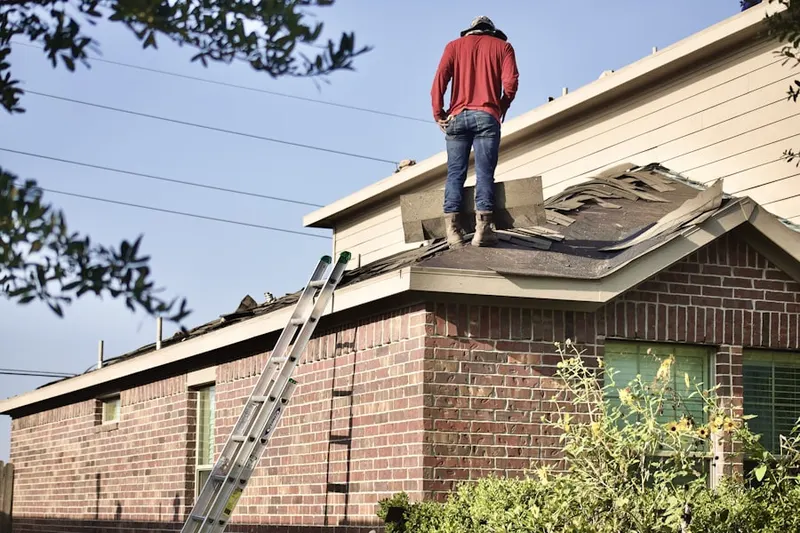 Professional roofer working on a residential roof in Salem End Road